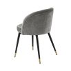 A luxurious set of two velvet dining chairs with black tapered legs and golden caps