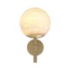 A luxurious antique brass wall lamp with an elegant, alabaster shade