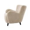 A luxurious fluffy cream-coloured mid-century inspired armchair
