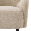 A luxurious fluffy cream-coloured mid-century inspired armchair
