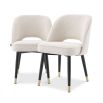Stunning upholstered chair with black tapered legs and brass caps. 