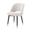Stunning upholstered chair with black tapered legs and brass caps. 