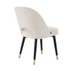 Stunning upholstered chair with black tapered legs and brass caps. 