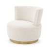A beautiful armchair with boucle upholstery and a brushed brass swivel base
