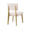 A luxurious modern brushed brass and boucle dining chair 