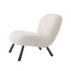 A luxurious boucle cream armchair with splayed, wooden legs