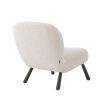 A luxurious boucle cream armchair with splayed, wooden legs