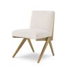 a luxurious boucle and brushed brass dining chair