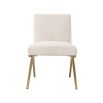 A luxurious boucle and brushed brass dining chair