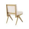 A luxurious boucle and brushed brass dining chair