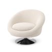 A luxurious contemporary swivel chair with boucle upholstery and a nickel swivel base