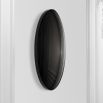 A luxurious round wall mirror with a black convex surface