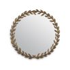 A beautiful botanical inspired decorative wall mirror featuring a wreath of leaves and a vintage brass finish