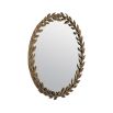 A beautiful botanical inspired decorative wall mirror featuring a wreath of leaves and a vintage brass finish