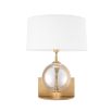 A luxurious crystal glass table lamp with a brushed brass base