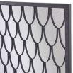 A black fire screen by Eichholtz with a scaled pattern and a close-meshed grille