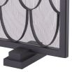 A black fire screen by Eichholtz with a scaled pattern and a close-meshed grille