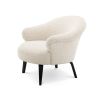 A luxurious boucle cream upholstered chair by Eichholtz with a curved silhouette and black bentwood legs