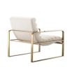 A luxurious boucle upholstered armchair with a brushed brass base