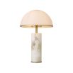 A Mid-Century Modern side lamp by Eichholtz with cylindrical alabaster base, dome-shaped white glass lampshade and antique brass finish 