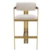 A luxury bar stool by Eichholtz with a boucle seat and brushed brass legs