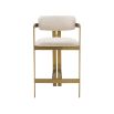 Glamorous counter stool with brushed brass frame and boucle cream upholstery.