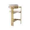 Glamorous counter stool with brushed brass frame and boucle cream upholstery.