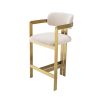 Glamorous counter stool with brushed brass frame and boucle cream upholstery.