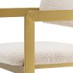 Glamorous counter stool with brushed brass frame and boucle cream upholstery.