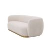 A sumptuous sofa by Eichholtz with an Lyssa Off-White upholstery and brushed brass base 