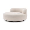 A luxurious round sofa by Eichholtz with a dreamy boucle cream upholstery and a sleek black base