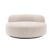 A luxurious round sofa by Eichholtz with a dreamy boucle cream upholstery and a sleek black base