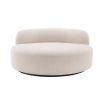 A luxurious round sofa by Eichholtz with a dreamy boucle cream upholstery and a sleek black base