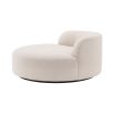 A luxurious round sofa by Eichholtz with a dreamy boucle cream upholstery and a sleek black base