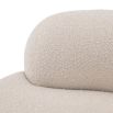 A luxurious round sofa by Eichholtz with a dreamy boucle cream upholstery and a sleek black base