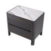 Elegant, modern bedside table with marble top and brass detail around the two drawers