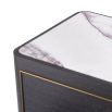 Elegant, modern bedside table with marble top and brass detail around the two drawers