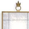 Gorgeous, antiqued wall mirror with ornamental top and brass frame