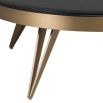 A luxury coffee table by Eichholtz with a bevelled black glass top and brushed brass finish 