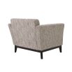 A modern Mid-Century inspired armchair by Eichholtz with a chic beige upholstery, a matte black frame, classic tufting and curved armrests