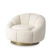 A cosy, boucle cream segmented swivel armchair with a brushed brass base