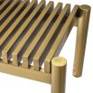 A glamorous bench by Eichholtz with two dreamy boucle cream upholstered seats and a beautiful brushed brass finish