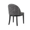 A luxury Cambon Black upholstered dining chair by Eichholtz with black legs