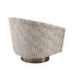 A woven beige armchair with a matte gold swivel base