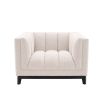 A luxurious boucle armchair in a creamy white upholstery with black legs