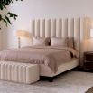 The Ditmar Headboard, upholstered in Bouclé cream fabric with deep channel stitching, creates a sophisticated dimensional effect with its clean lines and vertical sections.