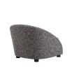 A gorgeous grey and black upholstered curved seat.