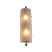 A delicate frosted glass wall lamp with antique brass details