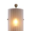 A delicate frosted glass wall lamp with antique brass details