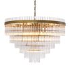 A glamorous art deco chandelier with brass accents by Eichholtz